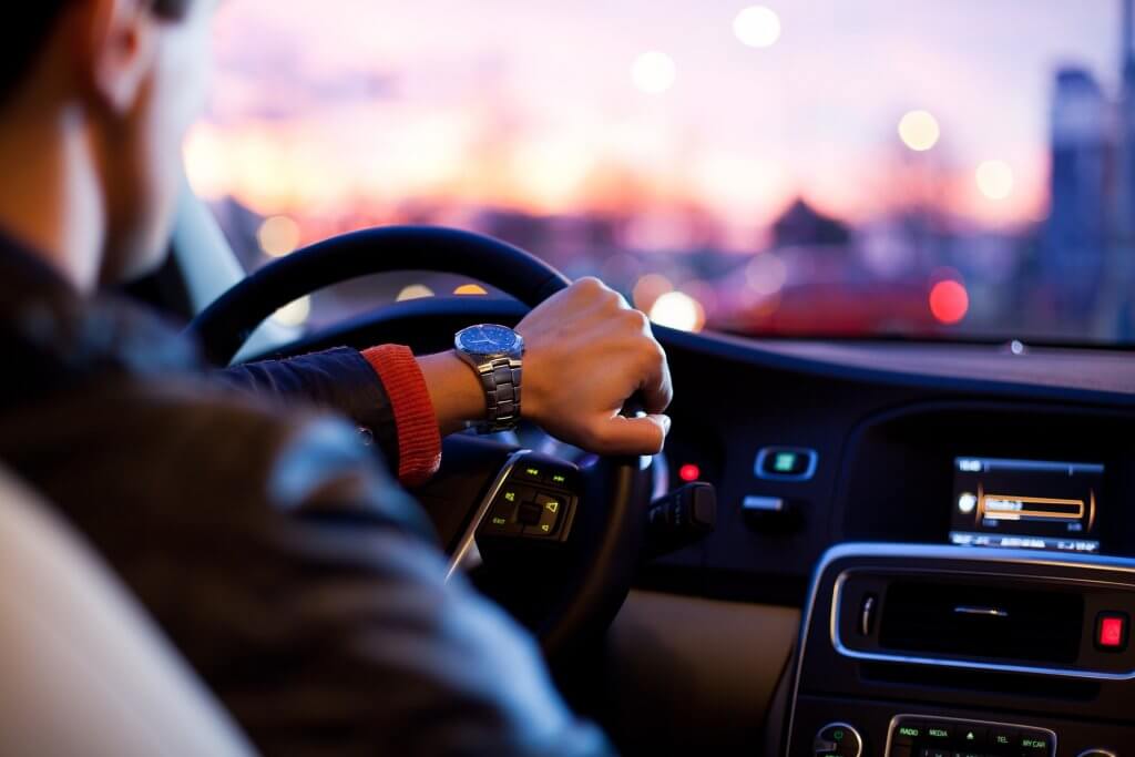 Man wearing a watch and driving