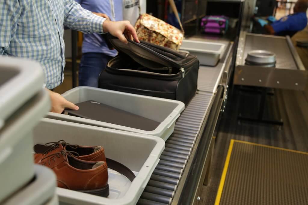 Placing laptop in bin at security